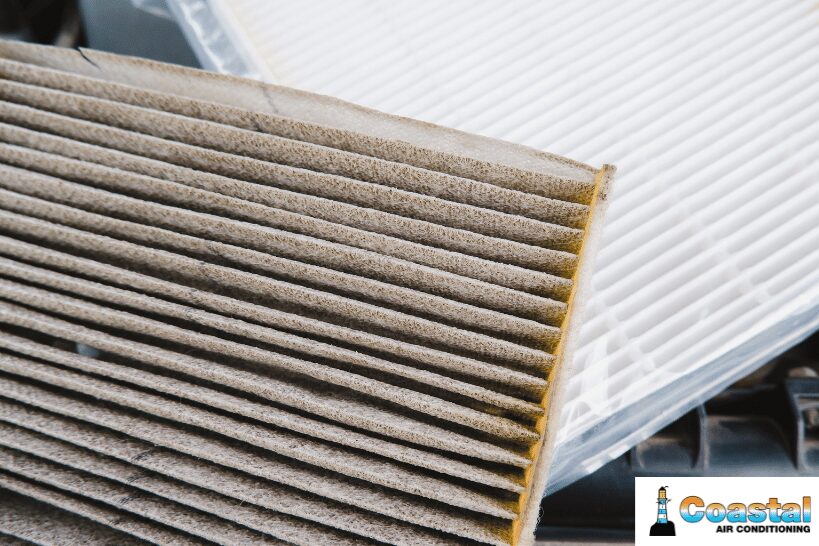 Clogged and dirty air filter removed from home furnace system