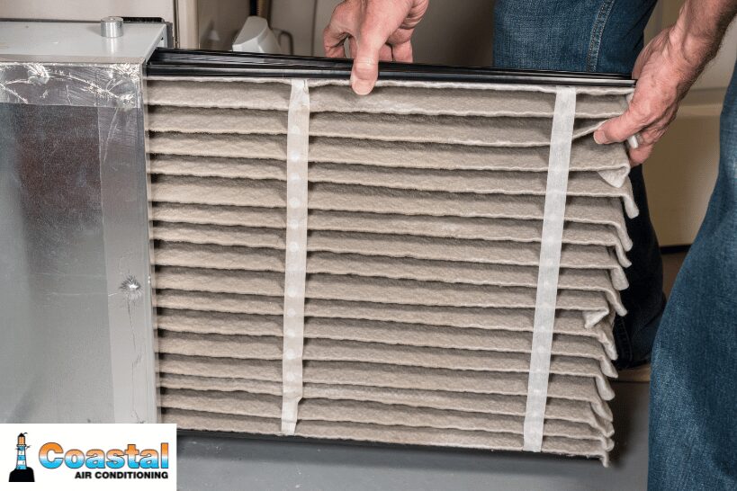 Pulling out old dirty HVAC air filter