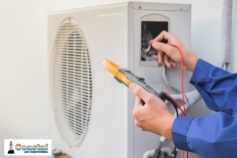 HVAC technician inspecting electrical components during a maintenance check
